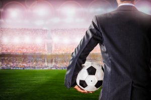 soccer manager against supporters in the stadium